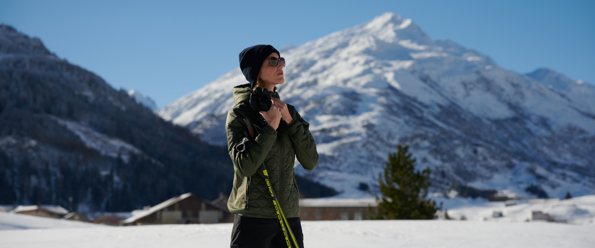 lady in ski outfit with Andermatt mountains in the background