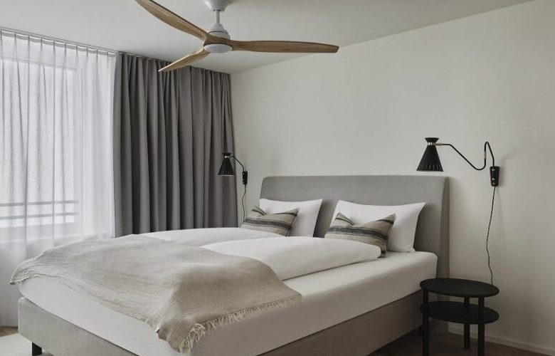 bedroom in grey and beige tone with ceiling fan